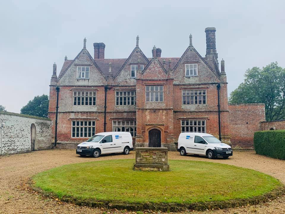 Asbestos survey vans parked outside listed building