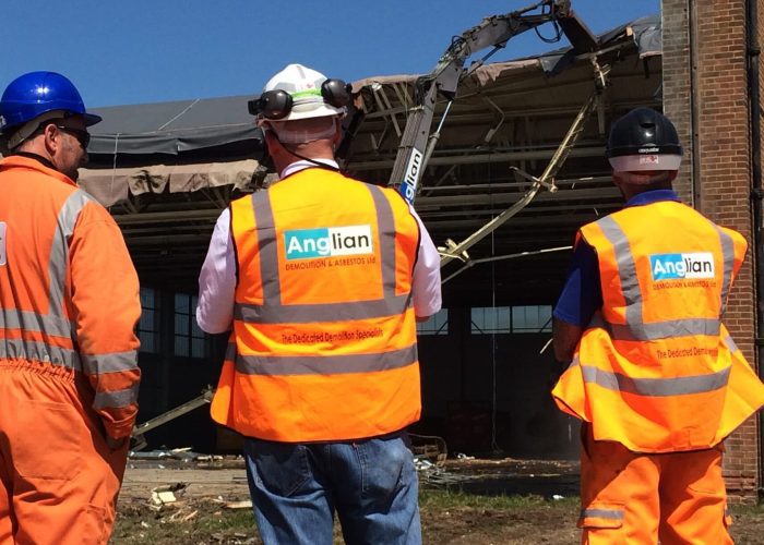 Three Anglian Demolition workers on demolition site