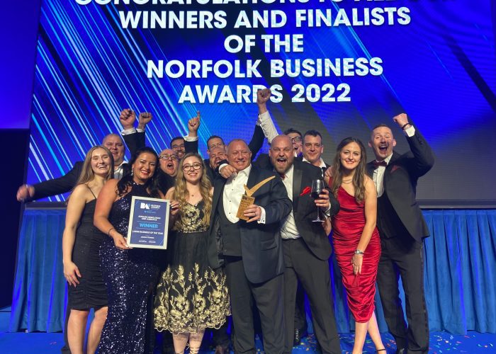 Anglian Demolition staff celebrating on stage at the Norfolk Business Awards